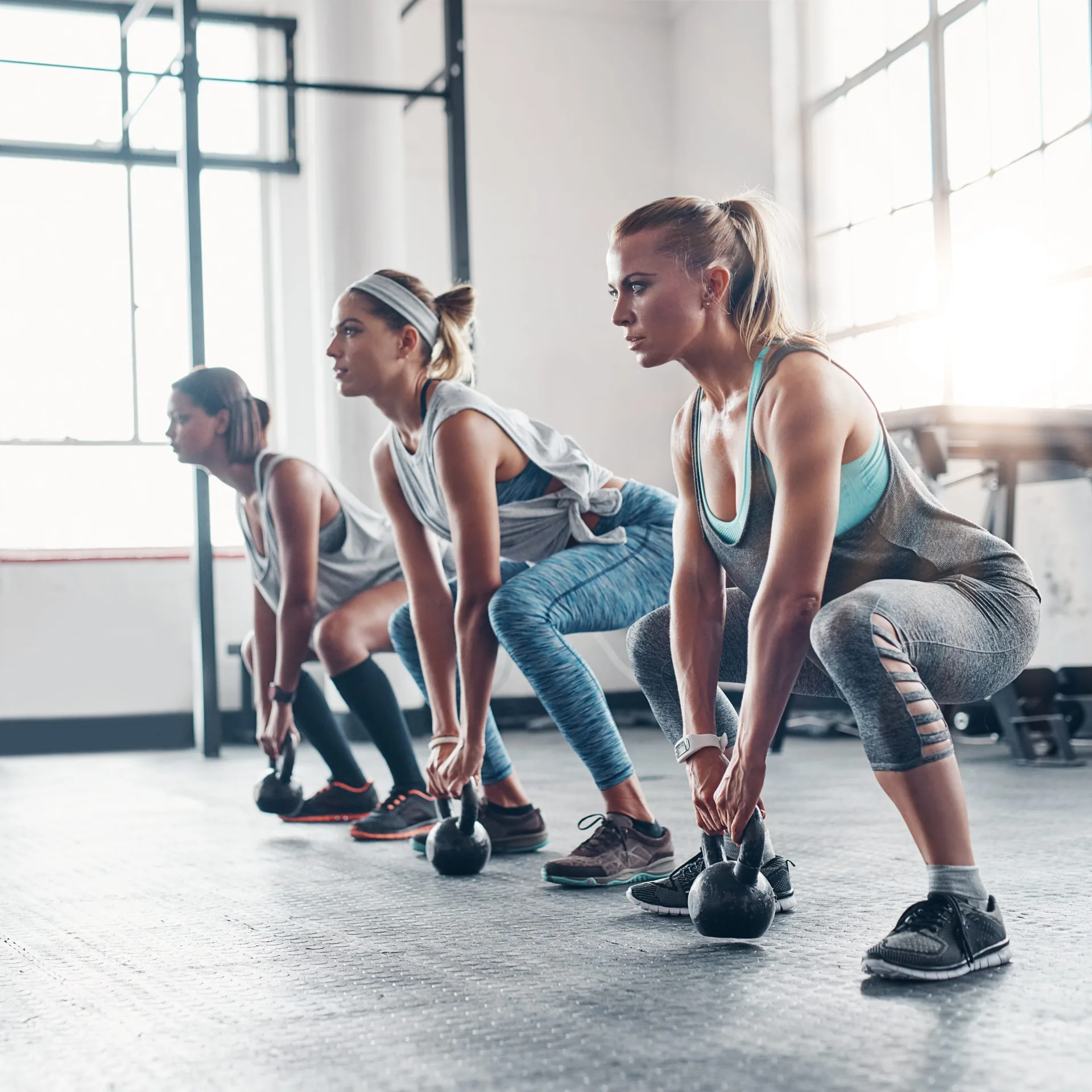 Group-exercise-and-women-training-kettlebell-and-workout-goal-with-wellness