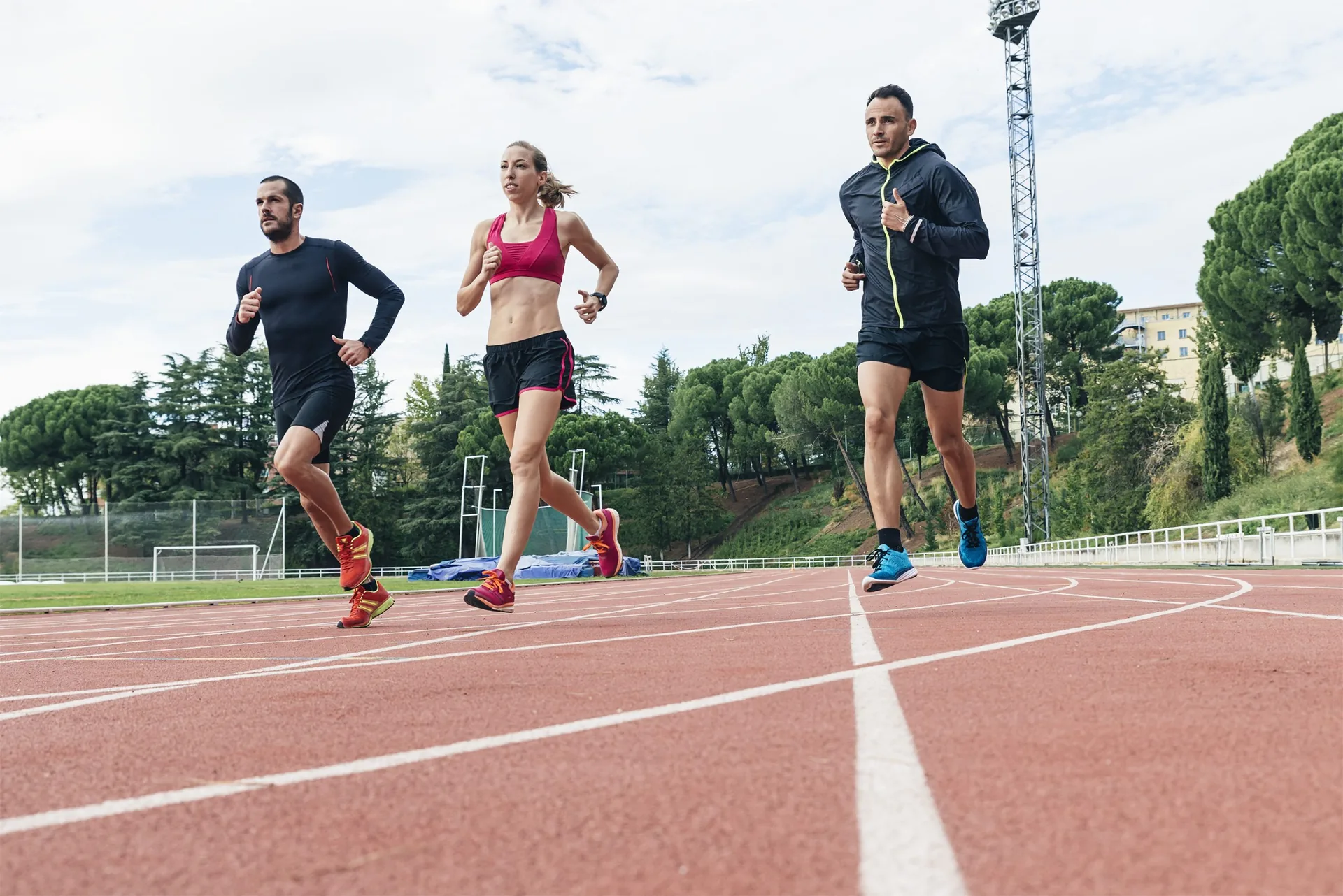 Group-of-young-athletics-people-running-on-the-track-field