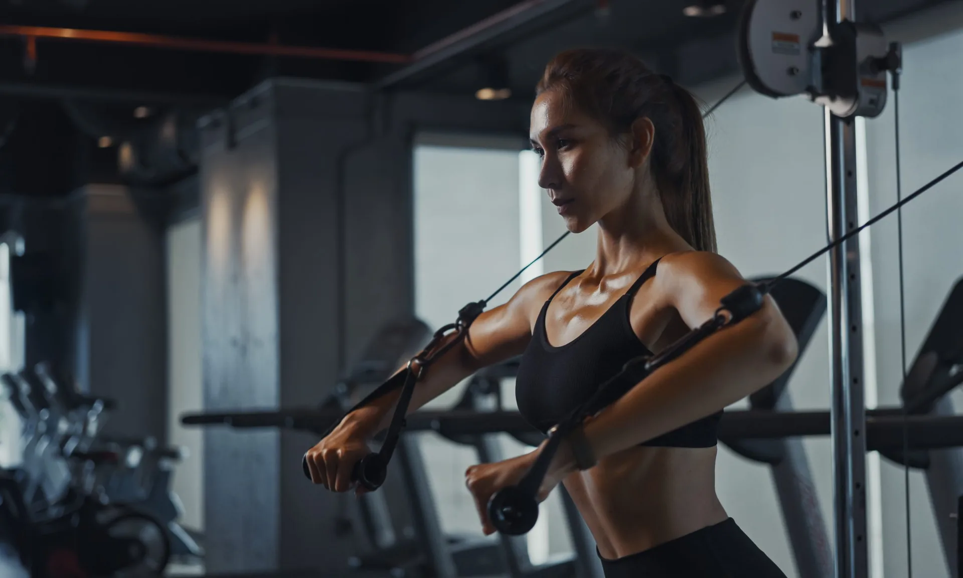 Sporty-woman-exercising-on-multistation-at-gym-for-arm-and-shoulders-muscles