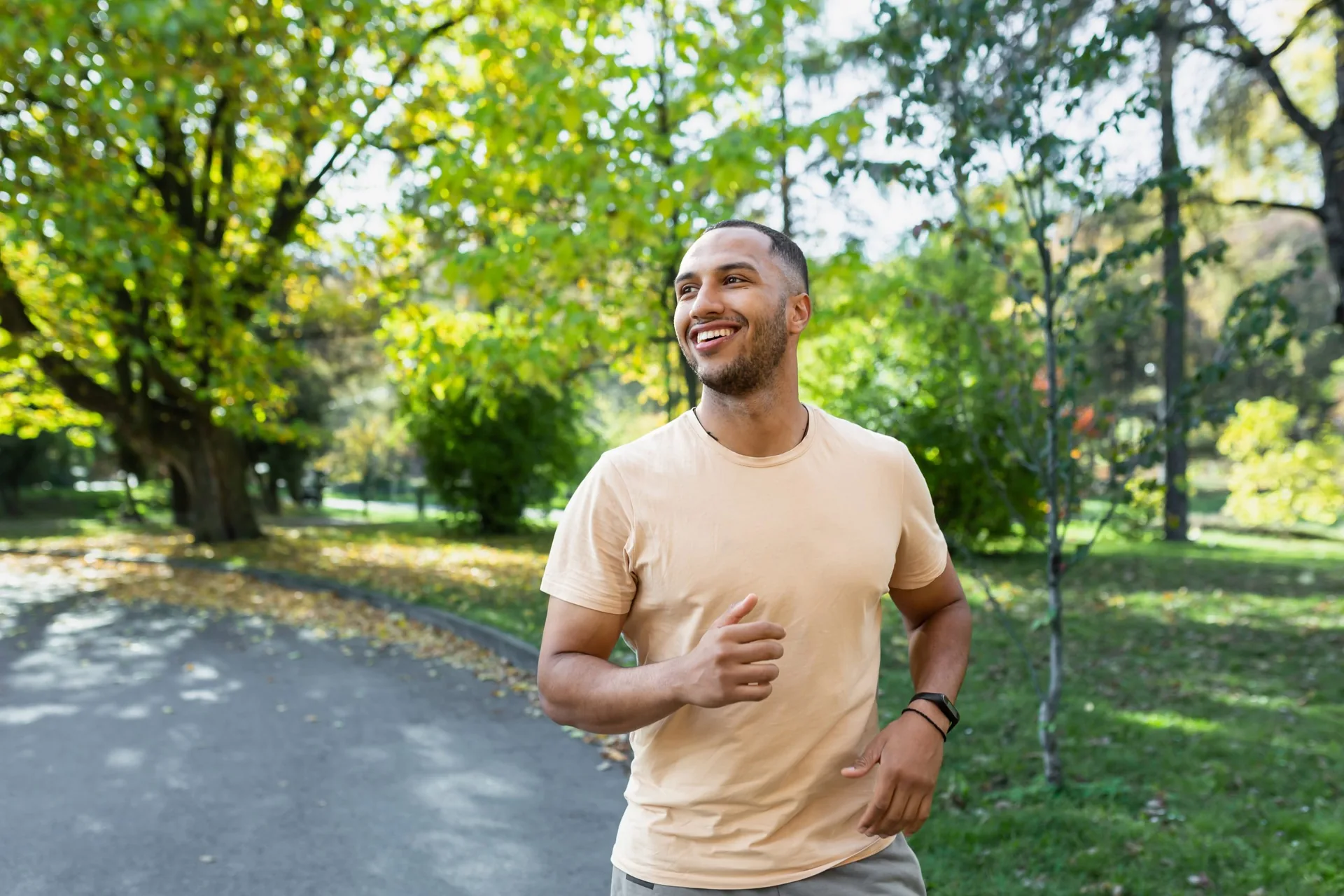 cheerful-successful-hispanic-man-jogging-park