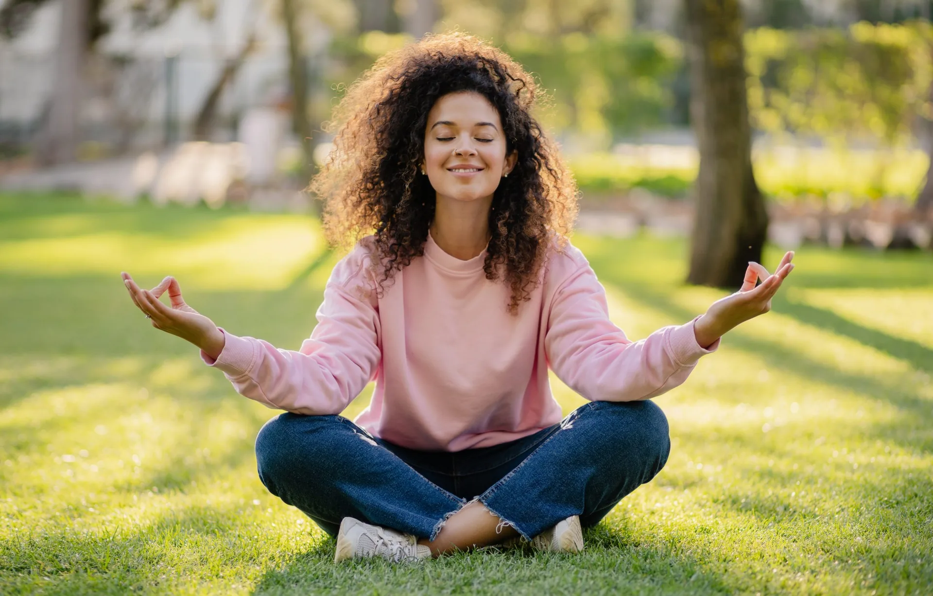 pretty-young-curly-woman-making-digital-detox-in-park