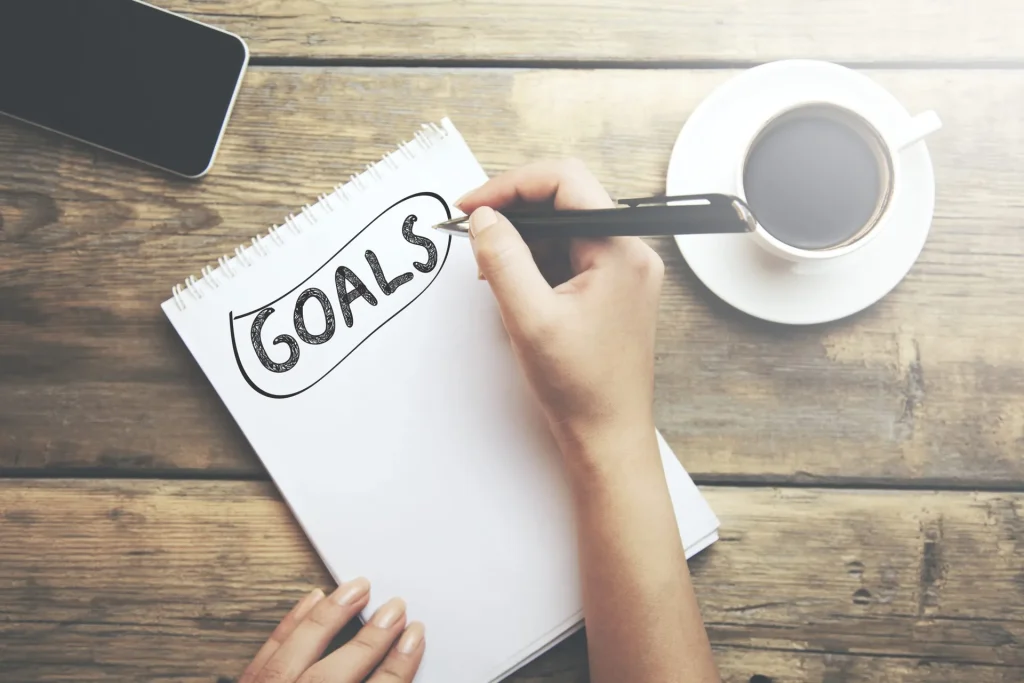 goals-memo-written-on-notebook-woman