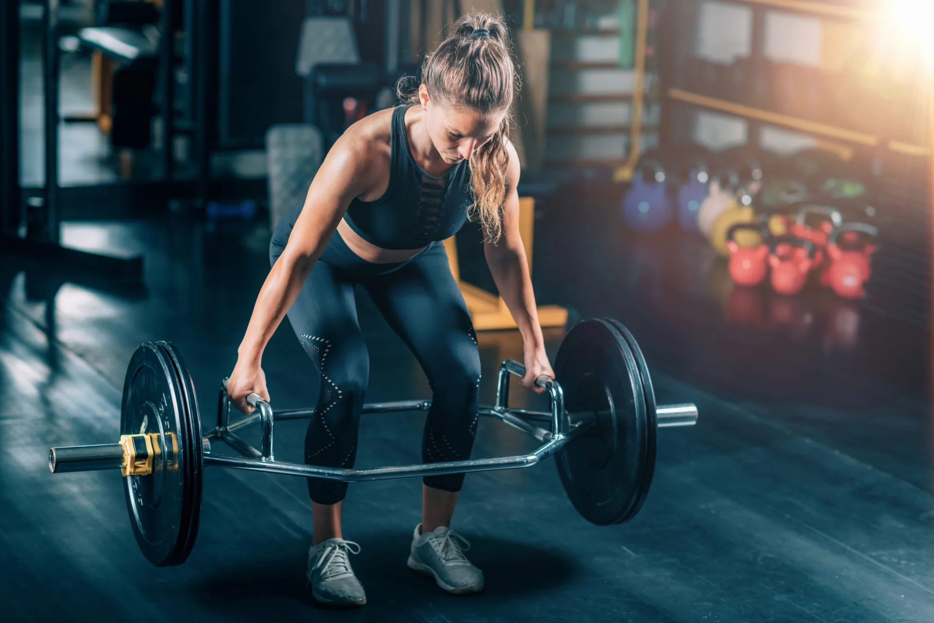 woman-doing-trap-bar-deadlift-gym