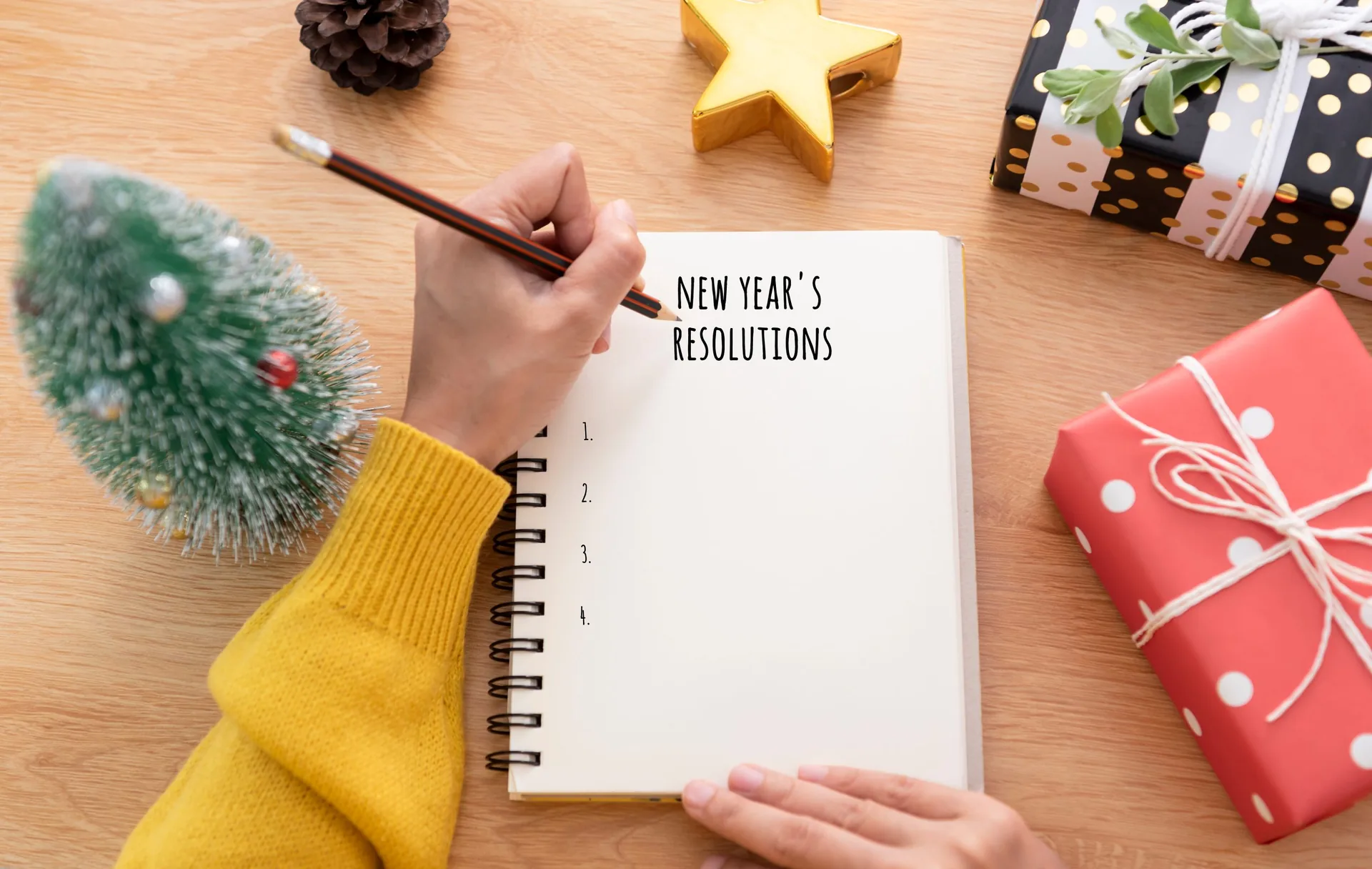 woman-hand-writing-new-years-resolution