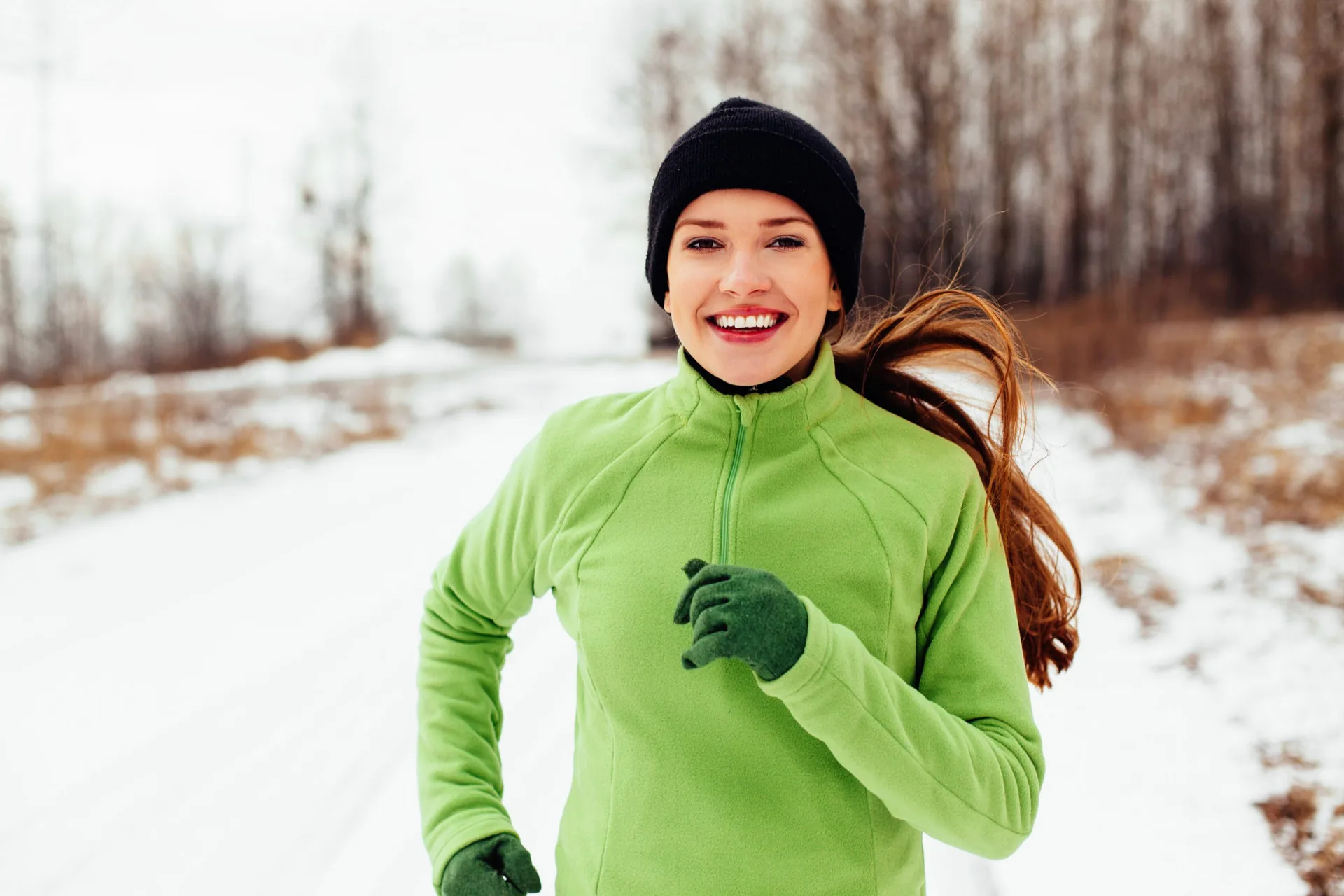 happy-young-woman-running-winter