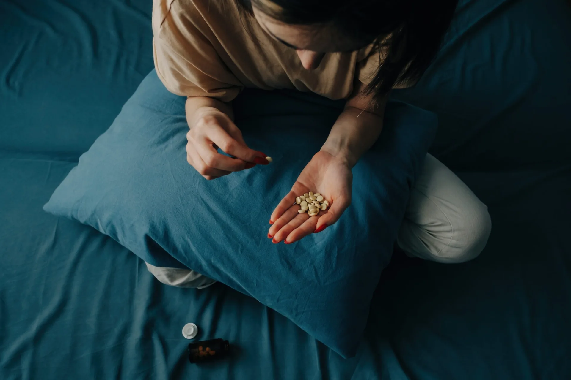 sad-young-unrecognizable-woman-takes-antidepressants