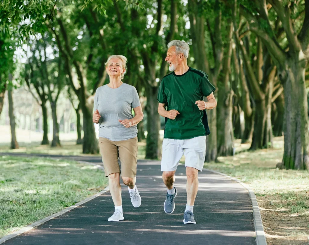 smiling-active-senior-couple-jogging-together