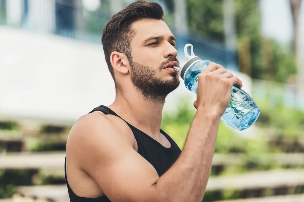 side-view-young-sportsman-drinking-water