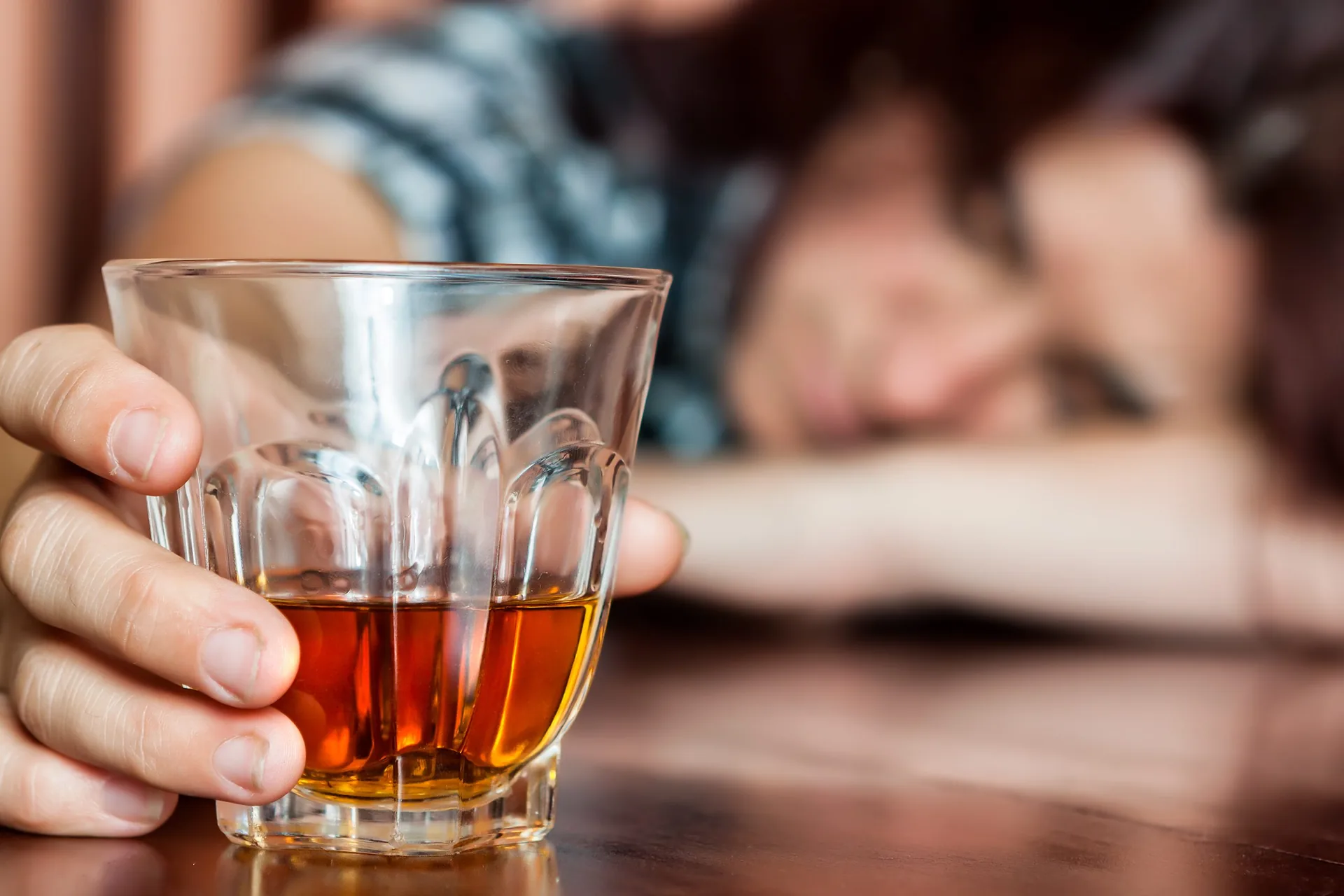 drunk-woman-holding-alcoholic-drink-sleeping