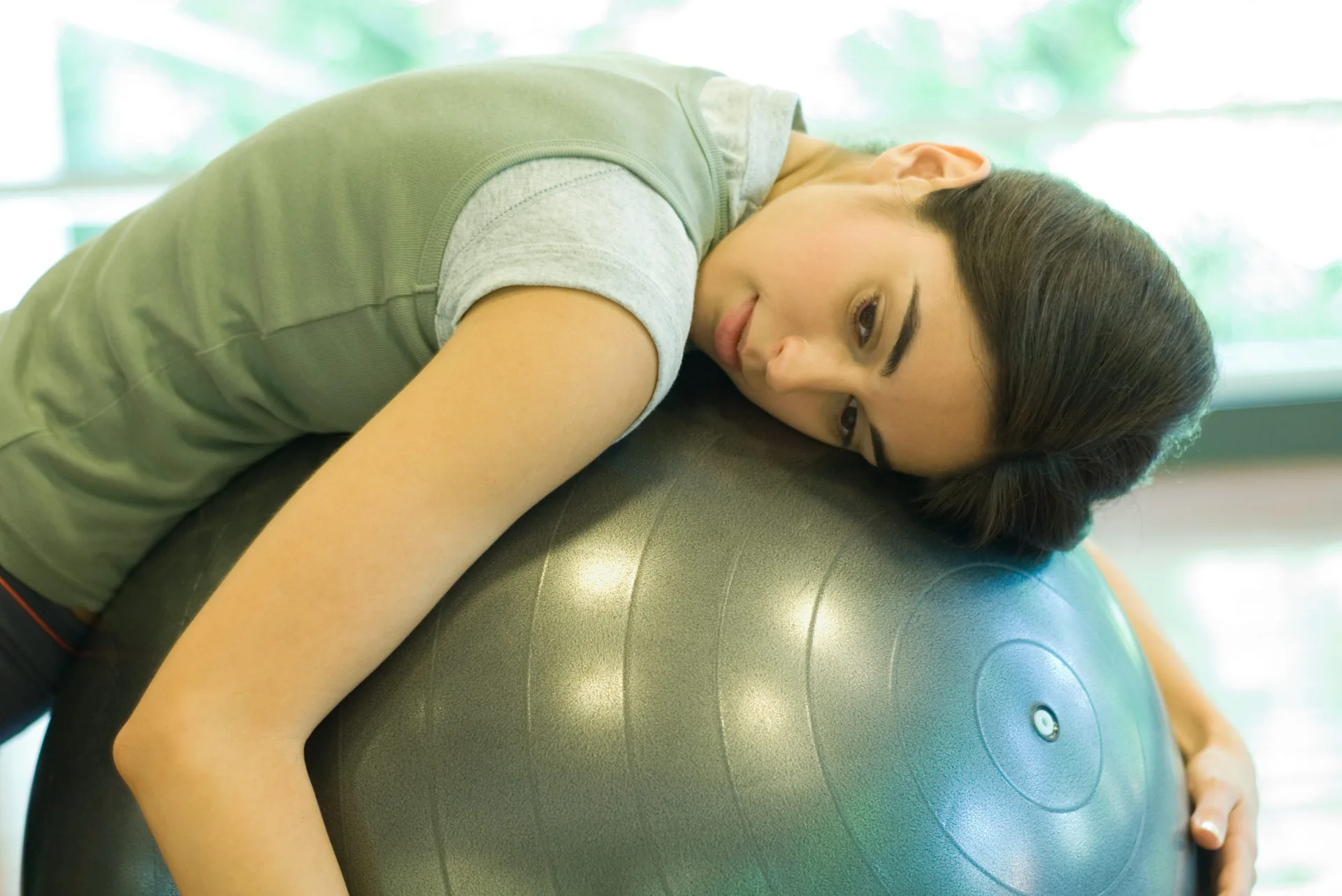 woman-resting-on-fitness-ball