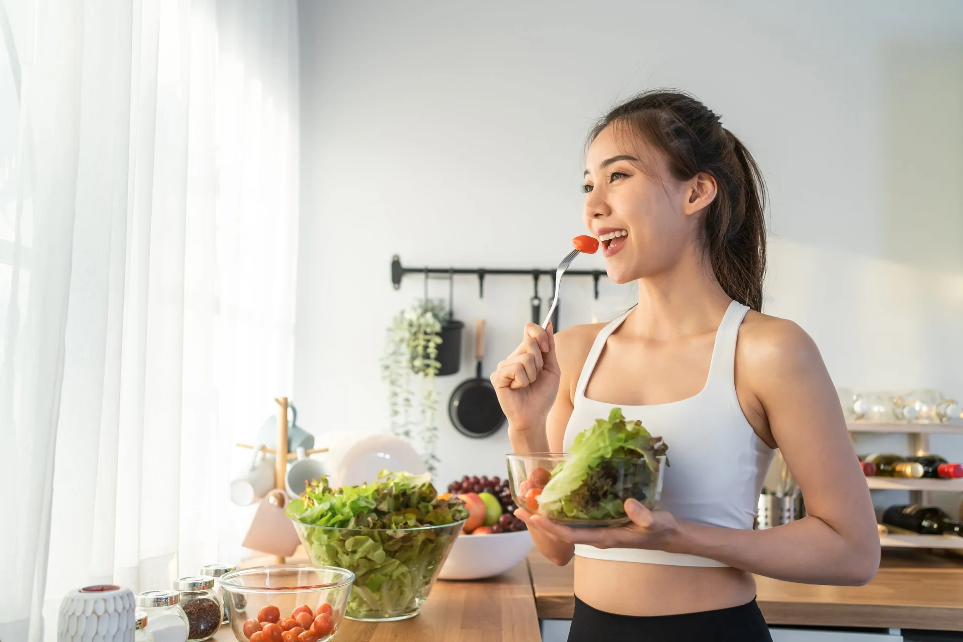 asian-attractive-sport-woman-holding-salad