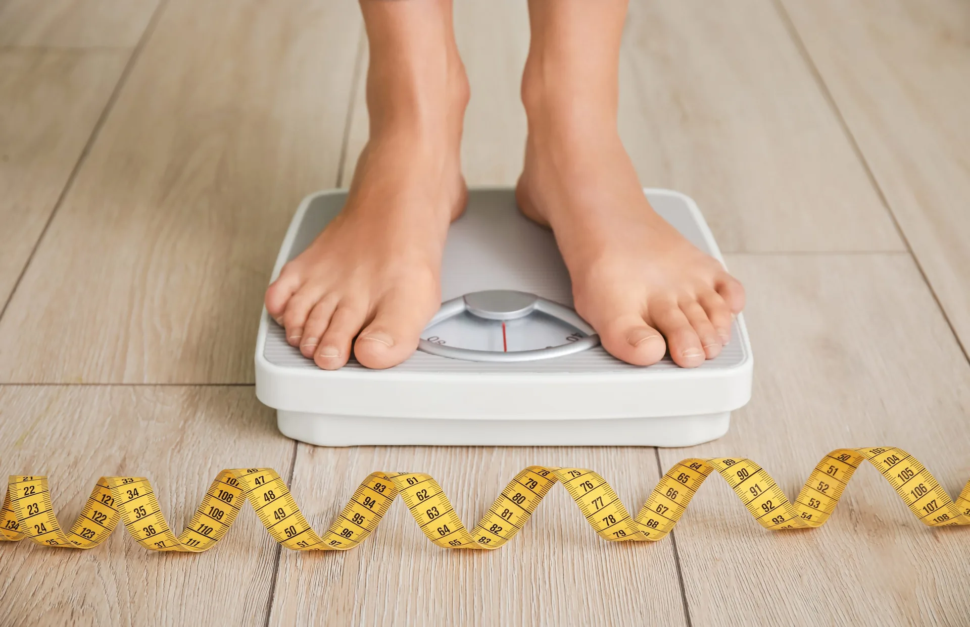 young-woman-measuring-her-weight-home