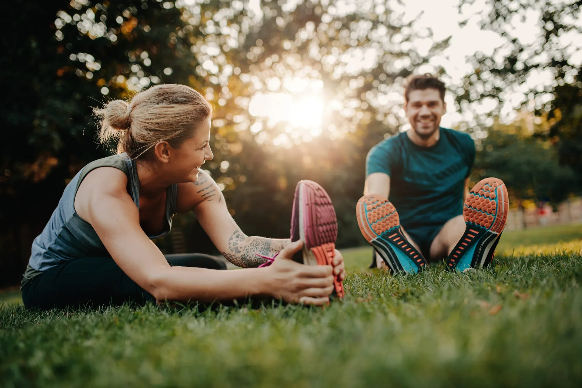 fitness-couple-stretching-outdoors-park-young