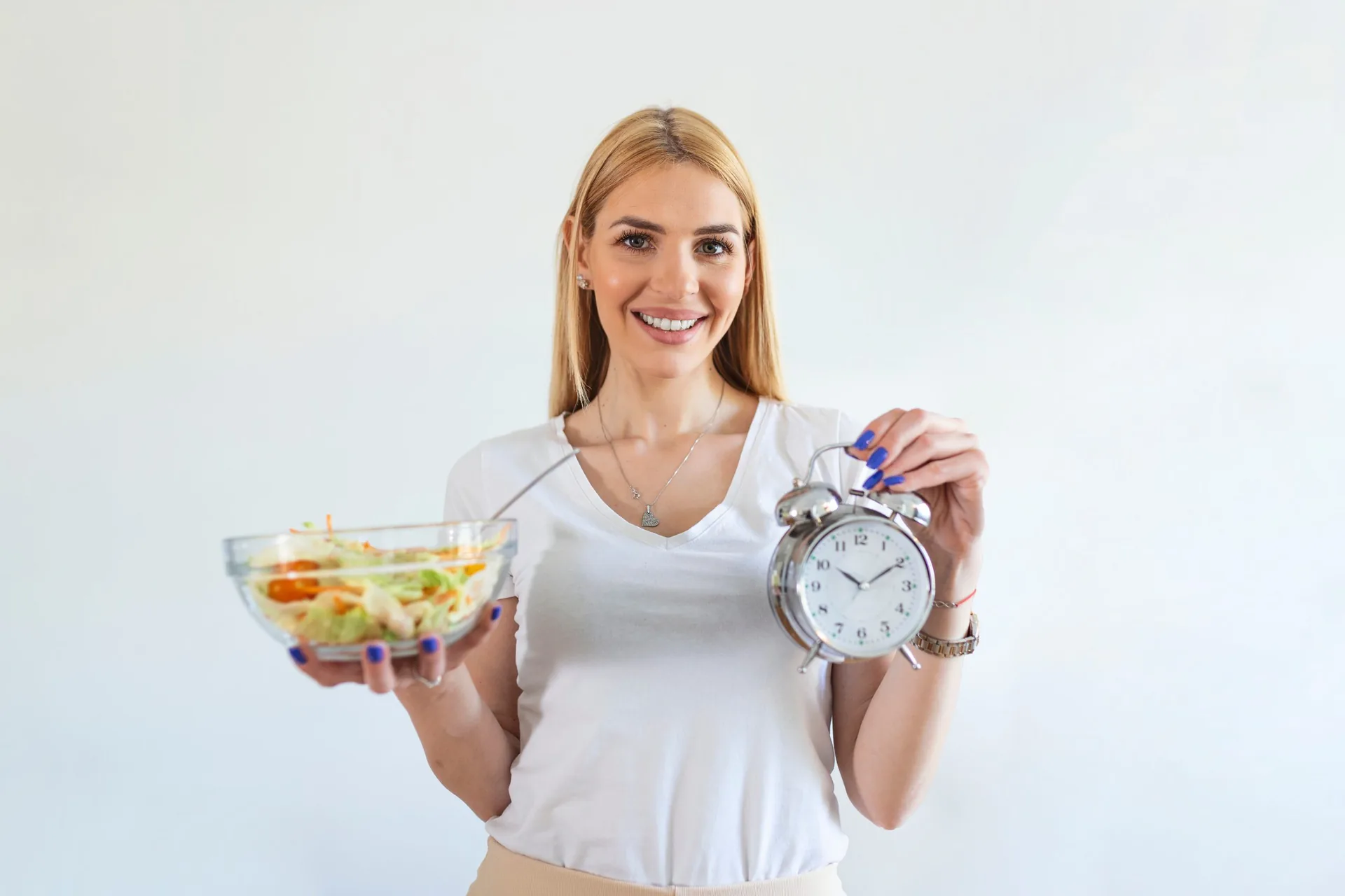 young-woman-holding-clock-healthy-food