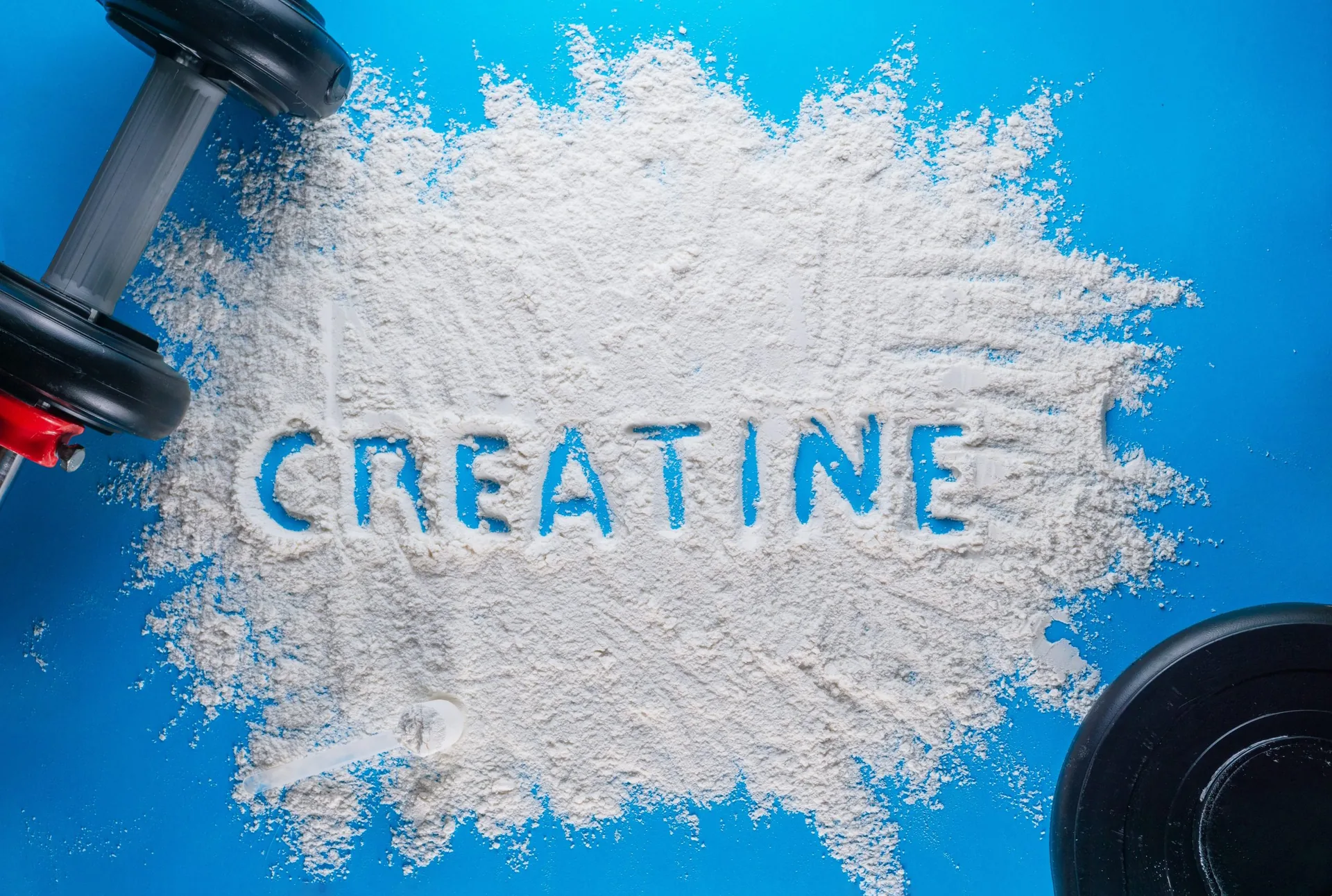 word-creatine-written-on-white-powder